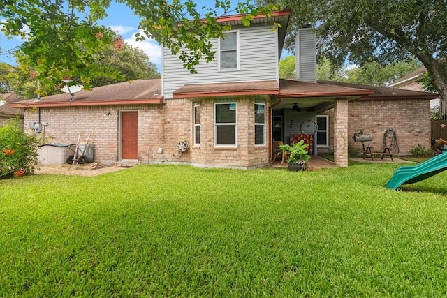 4537 Silver Hollow Dr, Corpus Christi, TX 78413 - back of house with a ceiling fan, a chimney, a lawn, a patio, and a playground