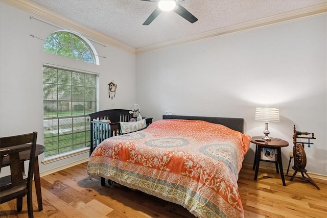 4537 Silver Hollow Dr, Corpus Christi, TX 78413 - bedroom with crown molding, wood finished floors, a textured ceiling, and ceiling fan