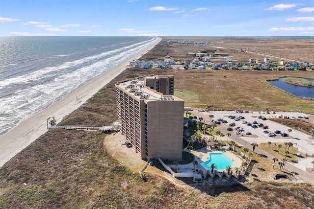 drone / aerial view featuring a water view and a beach view