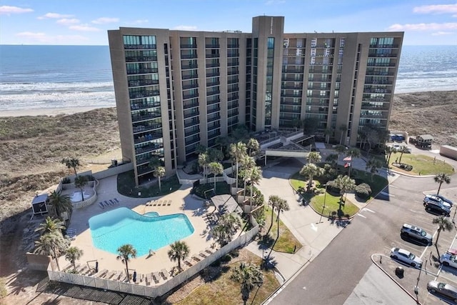 drone / aerial view featuring a water view and a view of the beach