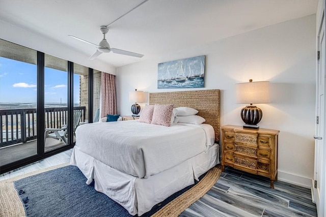 bedroom featuring baseboards, wood finished floors, a ceiling fan, and access to exterior