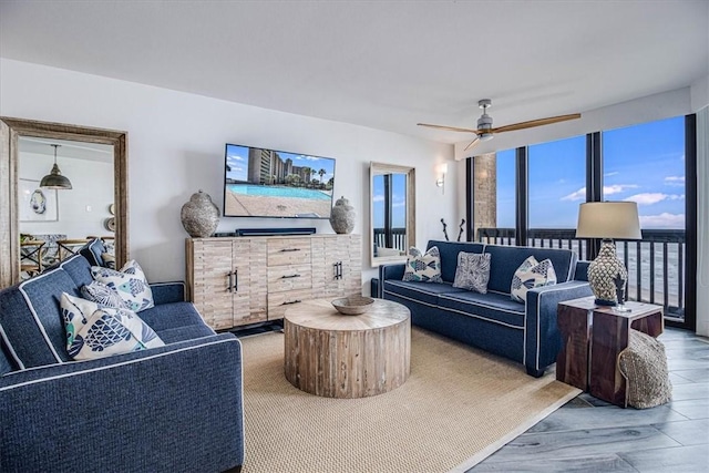 living room featuring a ceiling fan and wood finished floors