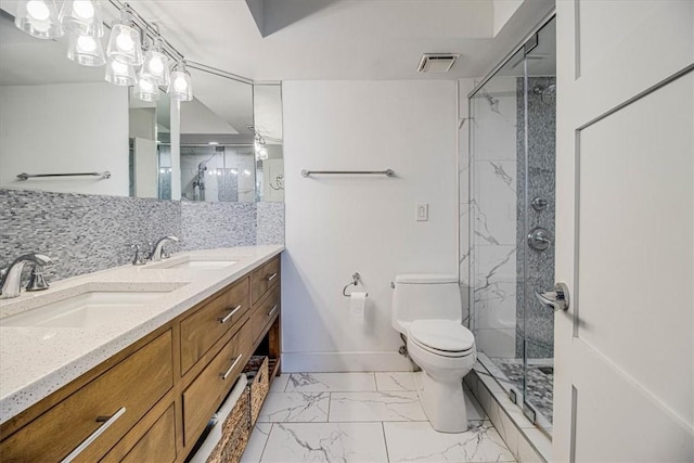 bathroom with marble finish floor, a marble finish shower, backsplash, and a sink