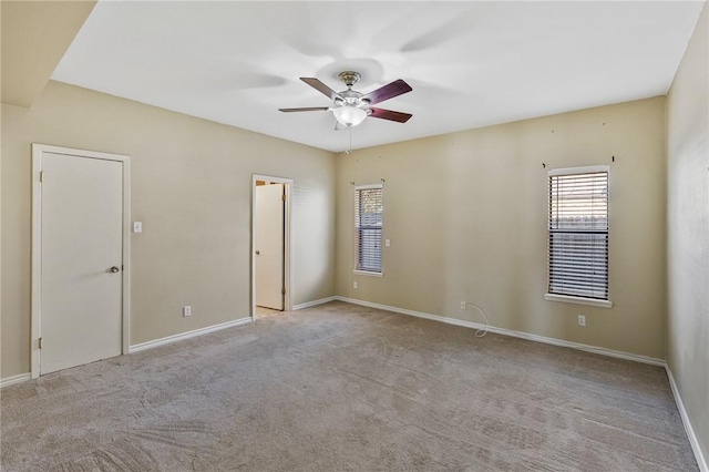 carpeted empty room featuring ceiling fan