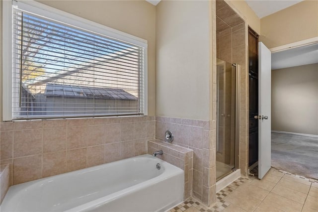 bathroom with tile patterned floors and shower with separate bathtub