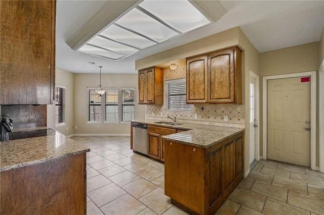 kitchen featuring dishwasher, sink, light stone countertops, tasteful backsplash, and decorative light fixtures