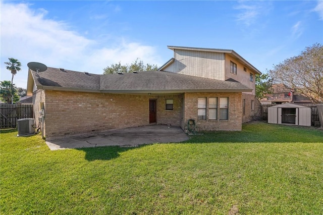 back of property with central air condition unit, a lawn, a patio, and a shed