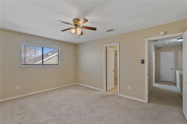 unfurnished bedroom featuring light colored carpet and ceiling fan