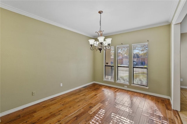 interior space with crown molding, hardwood / wood-style floors, and an inviting chandelier