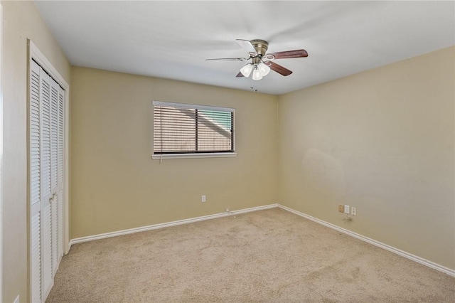 unfurnished bedroom featuring ceiling fan, a closet, and light carpet