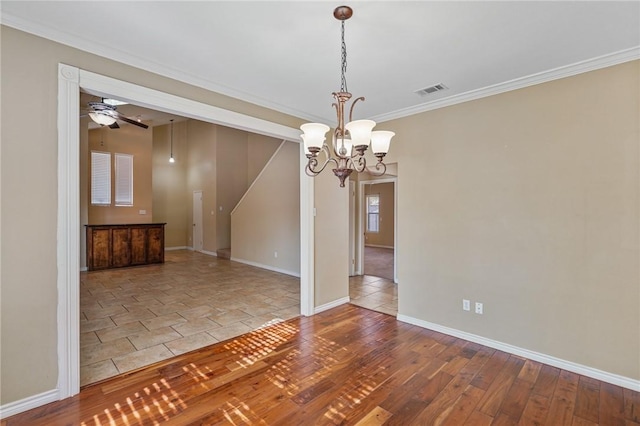 interior space featuring ceiling fan with notable chandelier, wood-type flooring, and crown molding