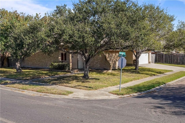 obstructed view of property with a front yard