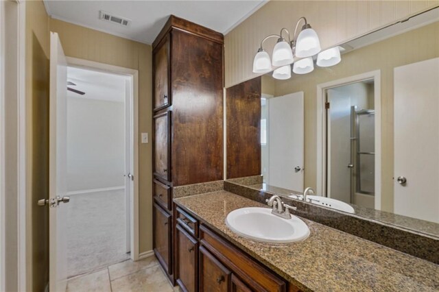 bathroom featuring tile patterned flooring, vanity, an enclosed shower, and ceiling fan with notable chandelier