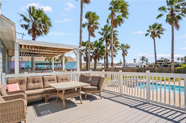 deck featuring fence, an outdoor living space, and a fenced in pool