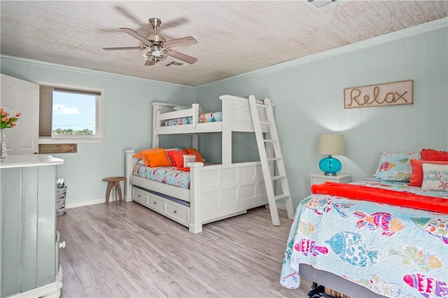 bedroom featuring ceiling fan, wood finished floors, and crown molding