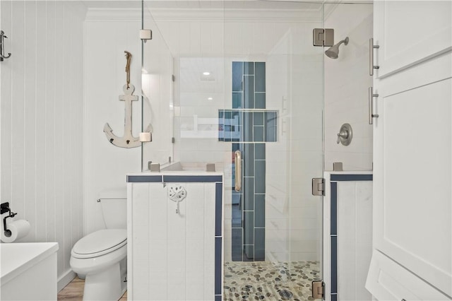 full bathroom with ornamental molding, a shower stall, and toilet