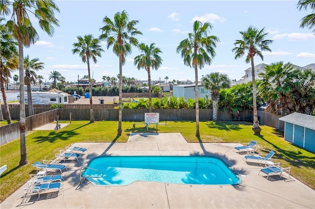 pool featuring a fenced backyard, a yard, and a patio