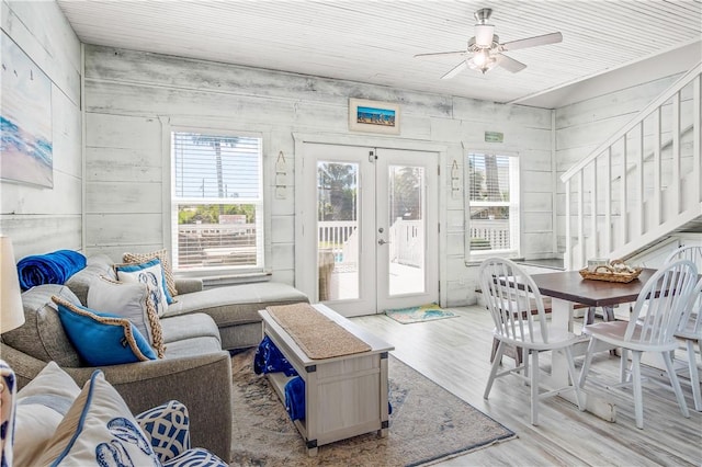 sunroom / solarium featuring ceiling fan and french doors