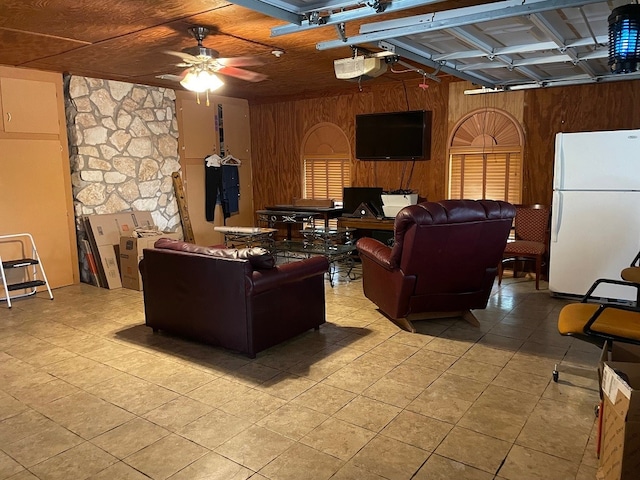 living room with wood walls and ceiling fan