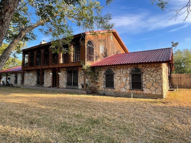 rear view of house with a yard