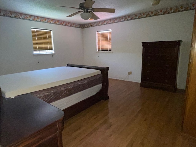 bedroom with wood-type flooring and ceiling fan