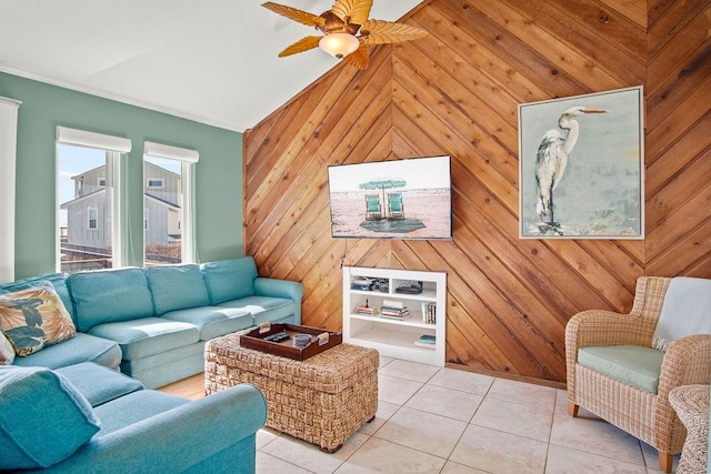 living room featuring lofted ceiling, light tile patterned floors, ceiling fan, and wood walls