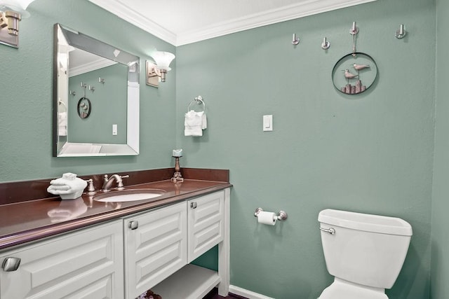 bathroom featuring toilet, vanity, and ornamental molding