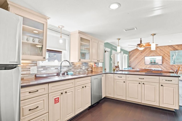 kitchen featuring ceiling fan, sink, hanging light fixtures, appliances with stainless steel finishes, and cream cabinets