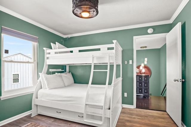 bedroom featuring hardwood / wood-style floors and crown molding