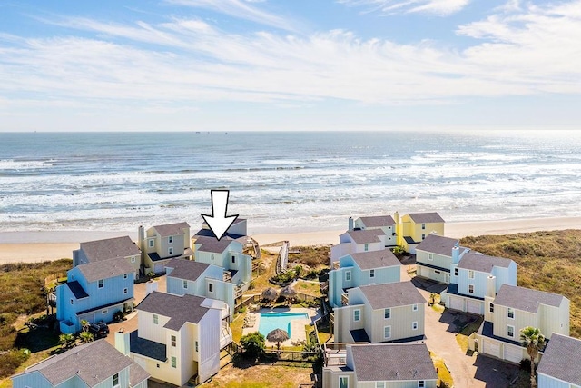 bird's eye view with a water view and a beach view