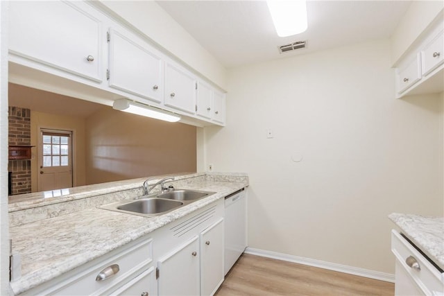 6117 Camwood Dr, Corpus Christi, TX 78415 - kitchen with a sink, white dishwasher, light wood-style flooring, light countertops, and white cabinetry