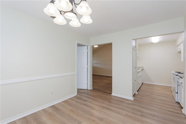 6117 Camwood Dr, Corpus Christi, TX 78415 - unfurnished dining area with a chandelier, light wood-style floors, and baseboards