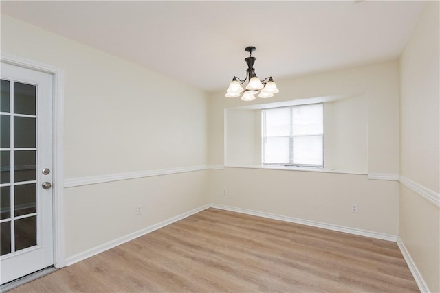 6117 Camwood Dr, Corpus Christi, TX 78415 - unfurnished room with a chandelier, light wood-style floors, and baseboards