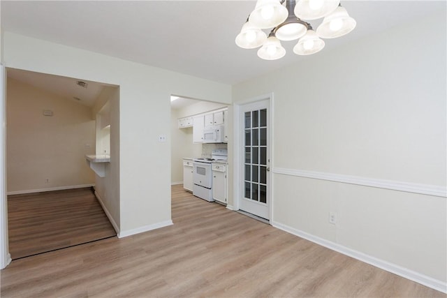 6117 Camwood Dr, Corpus Christi, TX 78415 - unfurnished dining area with a chandelier, light wood-style floors, and baseboards