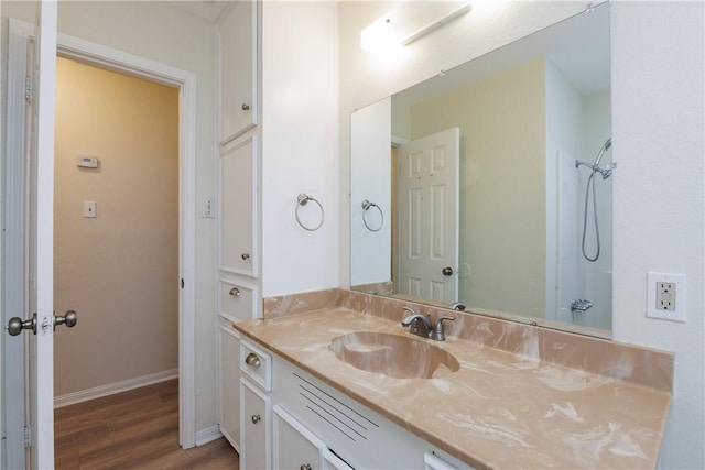 6117 Camwood Dr, Corpus Christi, TX 78415 - full bath featuring wood finished floors, vanity, baseboards, and a shower