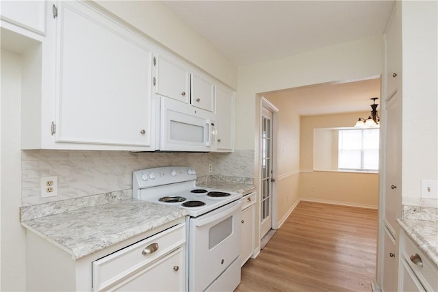 6117 Camwood Dr, Corpus Christi, TX 78415 - kitchen featuring white appliances, a chandelier, light wood-style flooring, white cabinets, and backsplash