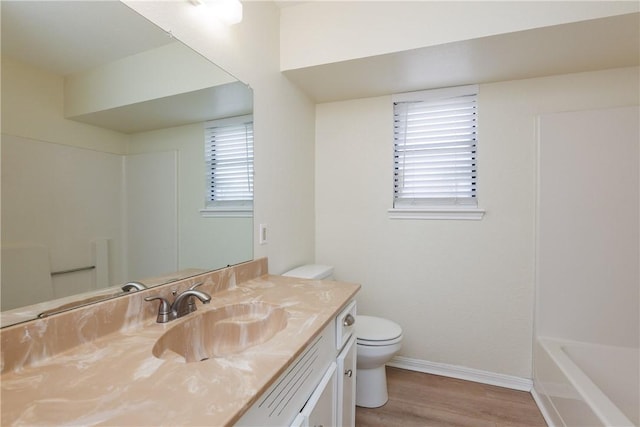 6117 Camwood Dr, Corpus Christi, TX 78415 - full bathroom with toilet, wood finished floors, baseboards, vanity, and a bath