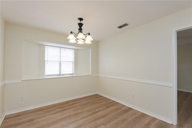 6117 Camwood Dr, Corpus Christi, TX 78415 - unfurnished room featuring light wood-style floors, a chandelier, and baseboards