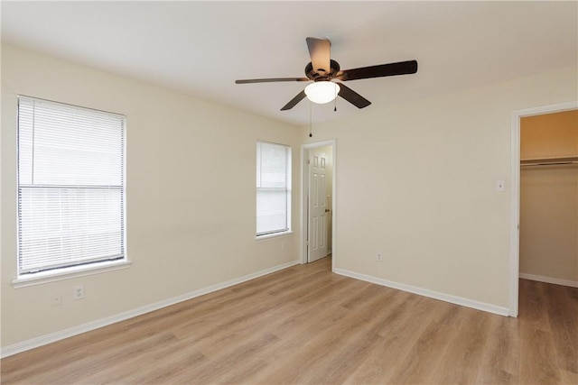 6117 Camwood Dr, Corpus Christi, TX 78415 - unfurnished bedroom with light wood-style floors, a spacious closet, baseboards, a closet, and a ceiling fan