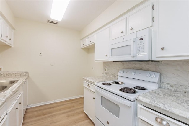 6117 Camwood Dr, Corpus Christi, TX 78415 - kitchen featuring white appliances, decorative backsplash, and white cabinets