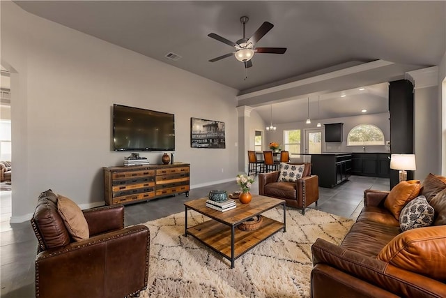 tiled living room featuring ceiling fan and decorative columns