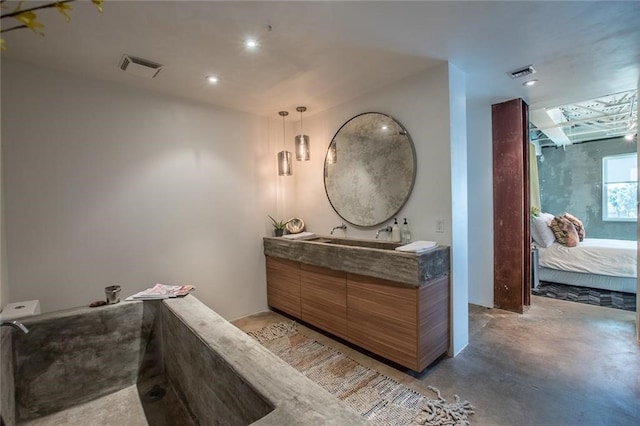 bathroom featuring concrete flooring and vanity