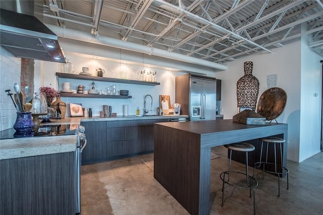 bar with dark brown cabinets, appliances with stainless steel finishes, sink, and ventilation hood