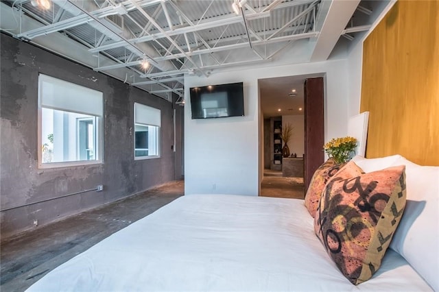 bedroom featuring concrete floors