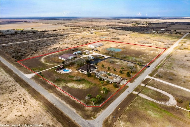 birds eye view of property with a rural view