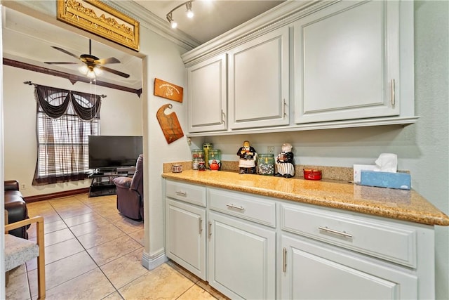 kitchen featuring ceiling fan, ornamental molding, track lighting, and light tile patterned floors