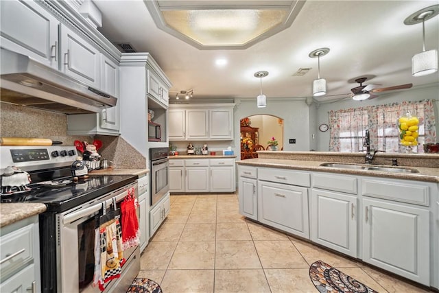 kitchen featuring stainless steel appliances, decorative light fixtures, sink, and light tile patterned floors