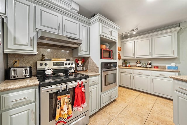 kitchen featuring tasteful backsplash, light tile patterned flooring, and appliances with stainless steel finishes