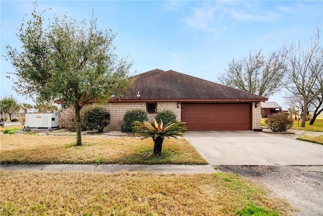 ranch-style home with a garage and a front yard