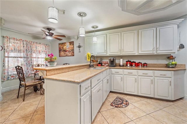 kitchen with sink, white cabinets, hanging light fixtures, light tile patterned floors, and kitchen peninsula